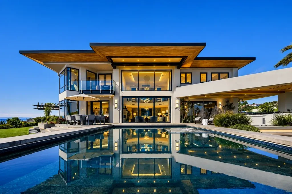 Modern two-story home with pool at dusk, the style of high-end residence financed with residential hard money loans in San Diego